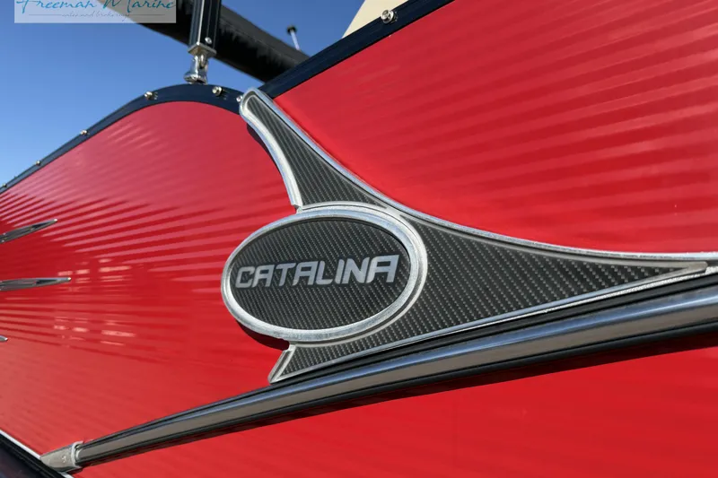 Slide: The Image of Close-up of 2019 Avalon Catalina Quad Lounge boat emblem on red exterior. - 5