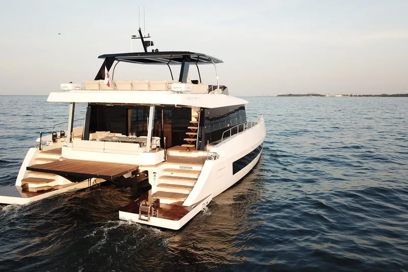 The Image of Luxurious 2026 Moon Yachts 6ty sailing on open sea at sunset. - 0