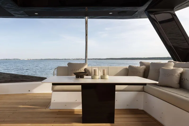 Slide: The Image of Luxurious Moon Yachts 6ty 2026 model with elegant deck seating and ocean view. - 14