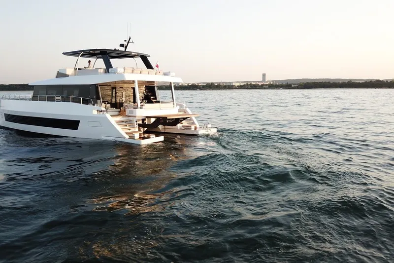 Slide: The Image of Luxury Moon Yachts 6ty 2026 cruising on serene waters at sunset. - 22