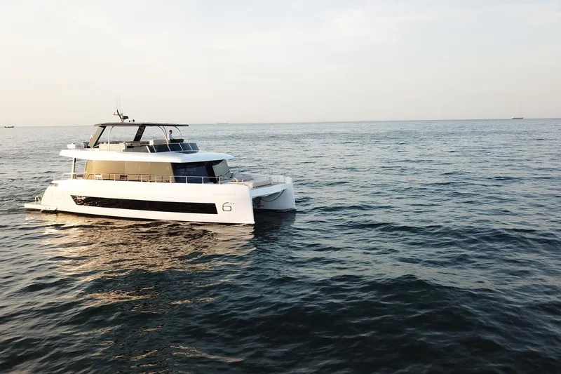 Slide: The Image of Luxury Moon Yachts 6ty 2026 model cruising on open sea at sunset. - 26