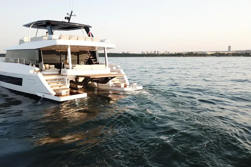 Slide: The Image of Luxurious 2026 Moon Yachts 6ty cruising on serene waters at sunset. - 7