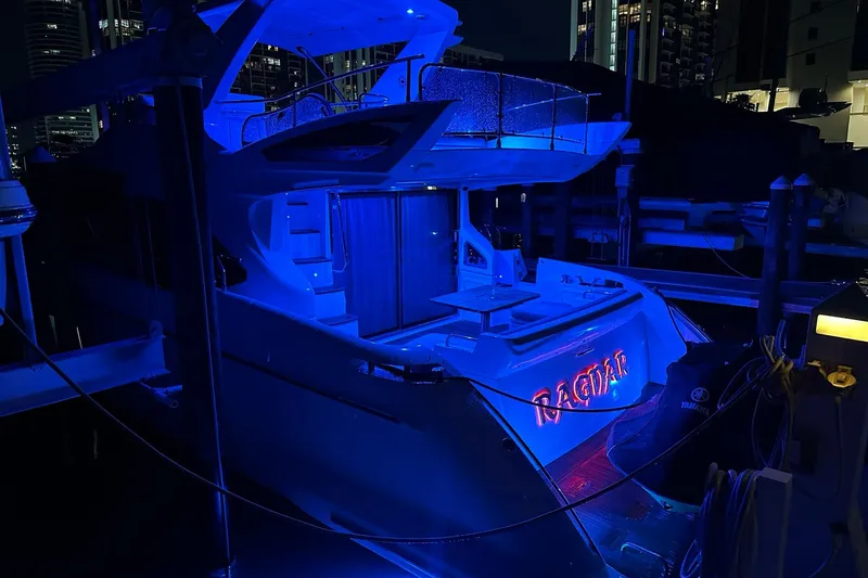 Slide: The Image of Azimut Fly 53 yacht, 2013 model, illuminated in blue at night, docked in a marina. - 11