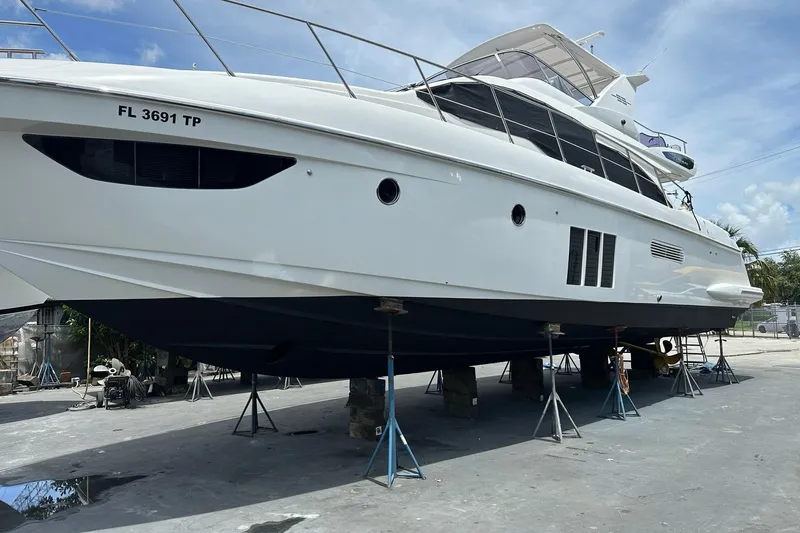 Slide: The Image of 2013 Azimut Fly 53 yacht on stands, side view, clear sky background. - 36