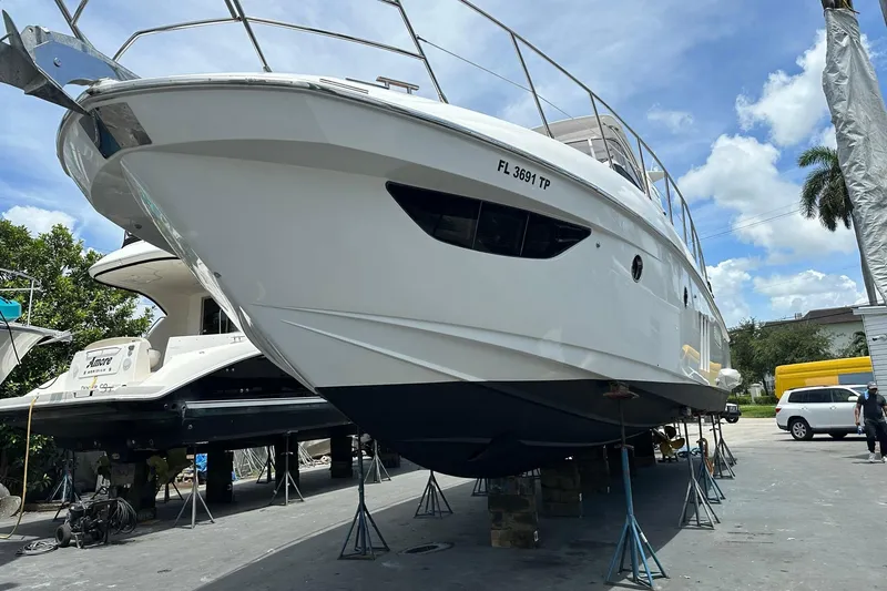 Slide: The Image of 2013 Azimut Fly 53 yacht on stands, ready for maintenance under a clear blue sky. - 37