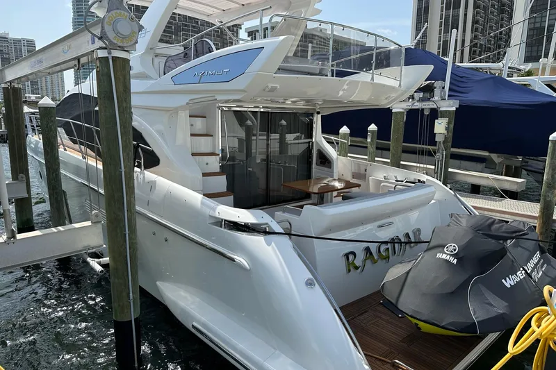 Slide: The Image of 2013 Azimut Fly 53 yacht docked, featuring sleek design and Yamaha WaveRunner. - 40