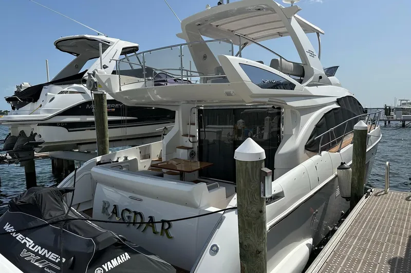 Slide: The Image of Azimut Fly 53 yacht, 2013 model, docked with Yamaha WaveRunner nearby. - 42