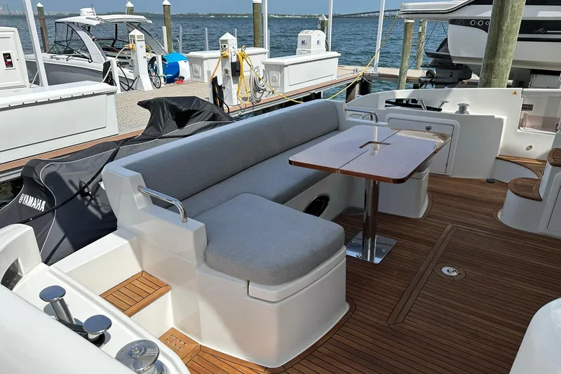Slide: The Image of Luxurious 2013 Azimut Fly 53 yacht deck with seating and table, docked by the water. - 45