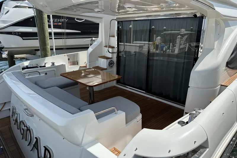 Slide: The Image of Luxurious 2013 Azimut Fly 53 yacht with elegant seating and wooden table on deck. - 46