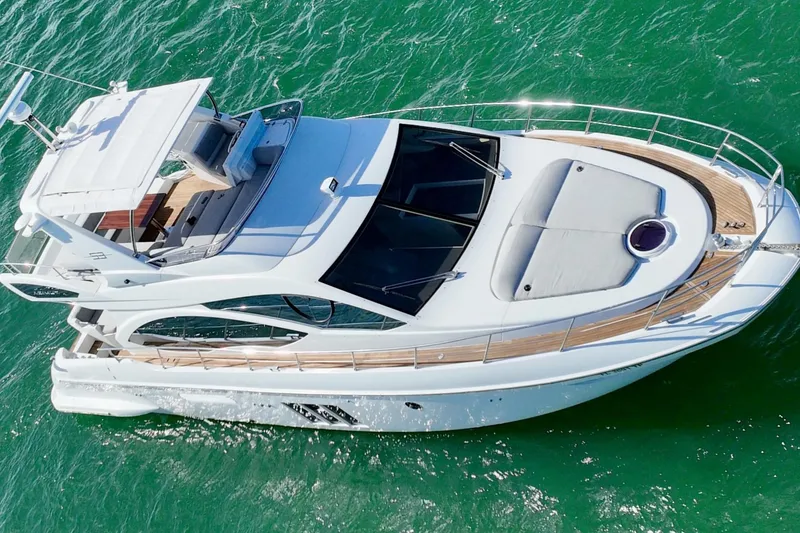 Slide: The Image of 2013 Azimut Fly 53 yacht cruising on vibrant green waters. - 5