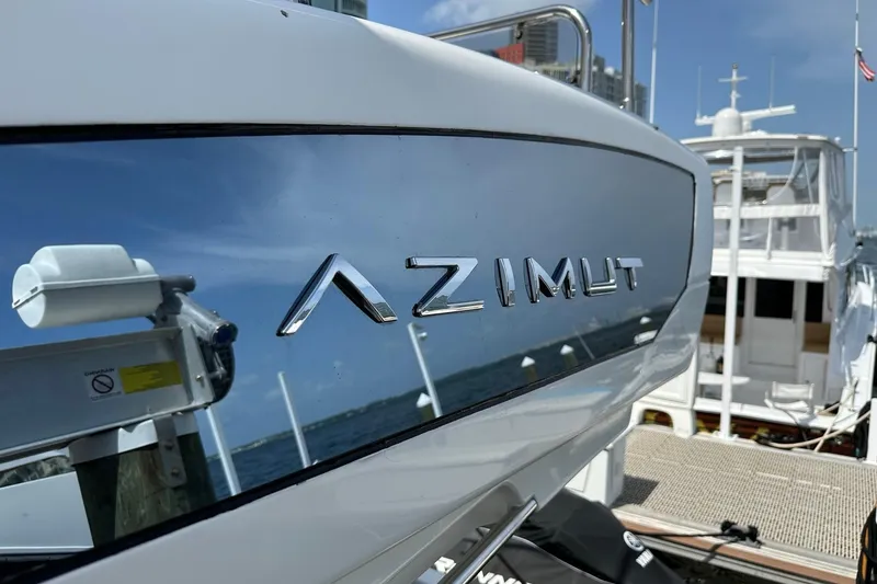 Slide: The Image of Azimut Fly 53 yacht, 2013 model, docked with cityscape background. - 54
