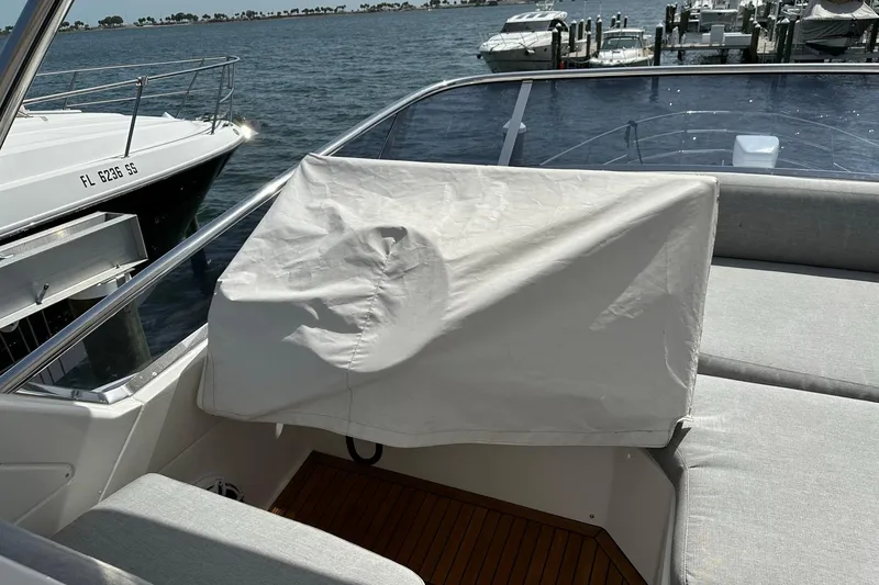 Slide: The Image of 2013 Azimut Fly 53 yacht interior with covered helm, docked by the water. - 60