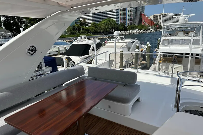 Slide: The Image of Luxurious 2013 Azimut Fly 53 yacht docked, featuring elegant outdoor seating and scenic marina view. - 62