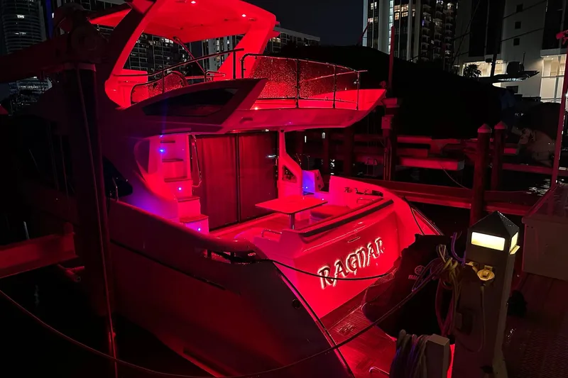 Slide: The Image of 2013 Azimut Fly 53 yacht illuminated with vibrant red lights at night. - 7