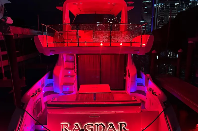 Slide: The Image of Red-lit Azimut Fly 53 yacht, 2013 model, docked at night with city skyline backdrop. - 8