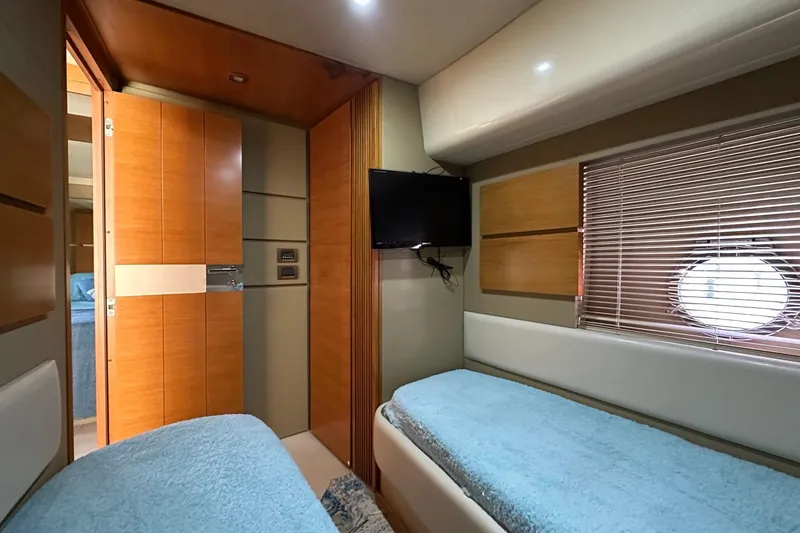 Slide: The Image of Interior of 2013 Azimut Fly 53 yacht cabin with twin beds and porthole window. - 84