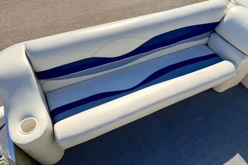 Slide: The Image of 2005 Bennington 205L boat seat with blue and white upholstery, featuring a built-in cup holder. - 20