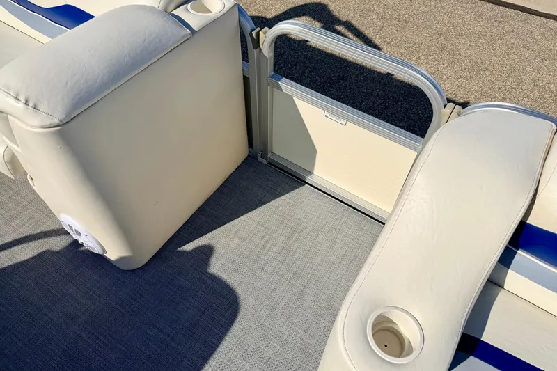 Slide: The Image of 2005 Bennington 205L boat interior with beige seating and cup holders. - 22