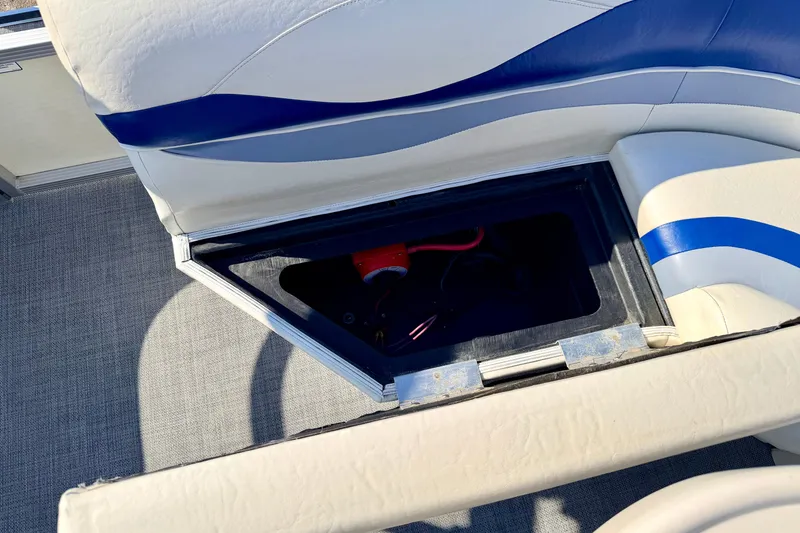 Slide: The Image of Open storage compartment in 2005 Bennington 205L boat seat, revealing interior details. - 28