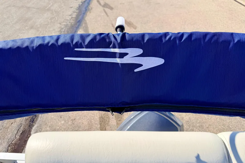 Slide: The Image of Blue cover on a 2005 Bennington 205L boat with logo. - 32
