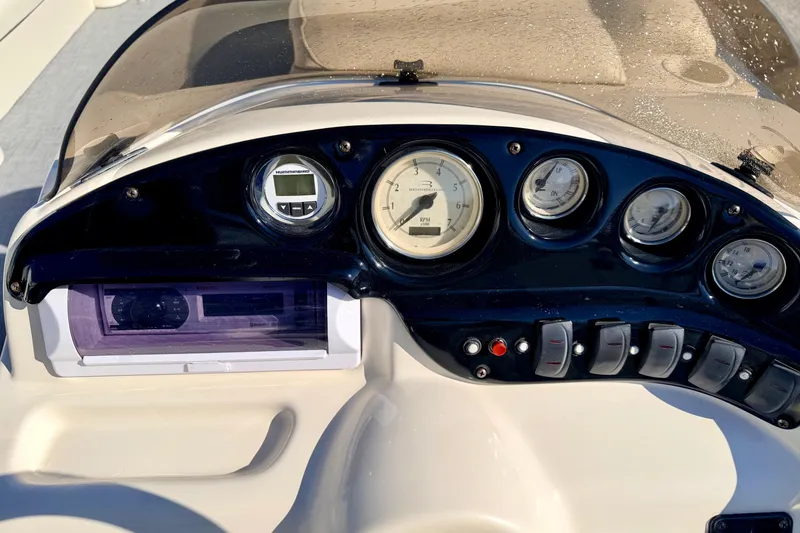 Slide: The Image of Dashboard of a 2005 Bennington 205L boat with gauges and controls. - 35