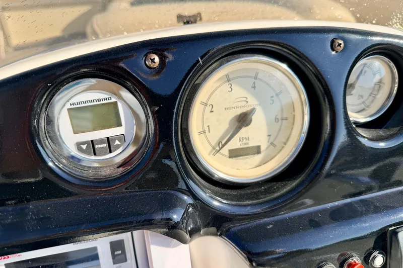 Slide: The Image of Dashboard of a 2005 Bennington 205L boat with gauges and Humminbird display. - 39