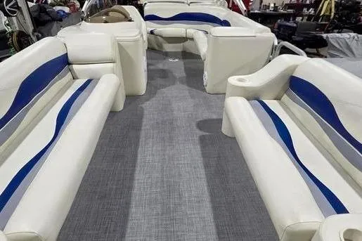 Slide: The Image of 2005 Bennington 205L pontoon boat with blue accents, docked on a sunny day. - 4