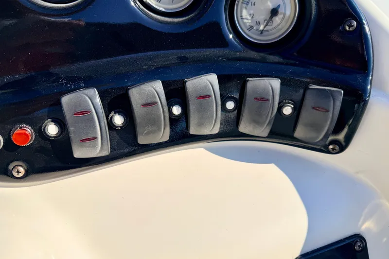 Slide: The Image of Dashboard controls of a 2005 Bennington 205L boat with switches and gauges. - 41