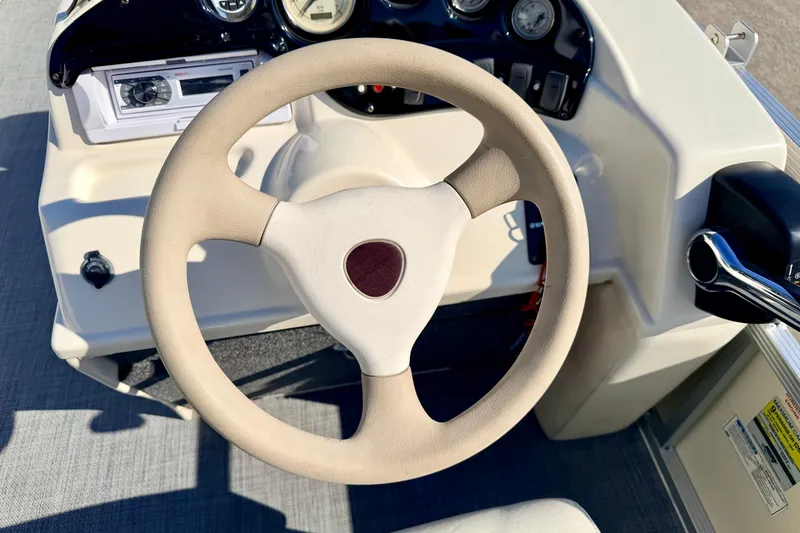 Slide: The Image of Steering wheel and dashboard of a 2005 Bennington 205L boat. - 42