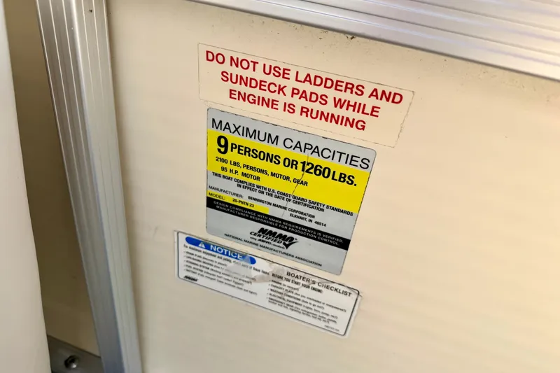 Slide: The Image of Capacity warning label on 2005 Bennington 205L boat, limits 9 persons or 1260 lbs. - 44