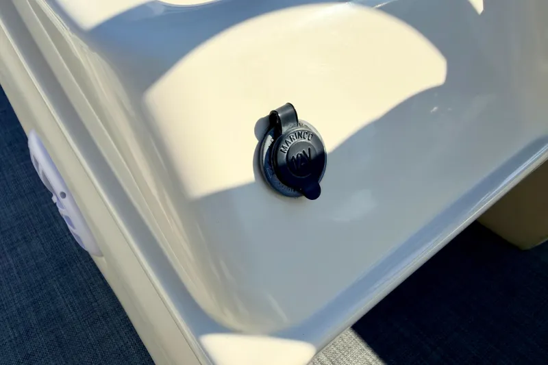 Slide: The Image of 12V power outlet on 2005 Bennington 205L boat, featuring Marinco cover. - 48