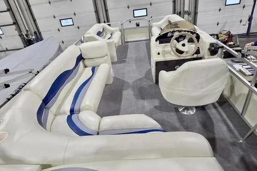 Slide: The Image of 2005 Bennington 205L pontoon boat on trailer, featuring spacious deck and sleek design. - 5