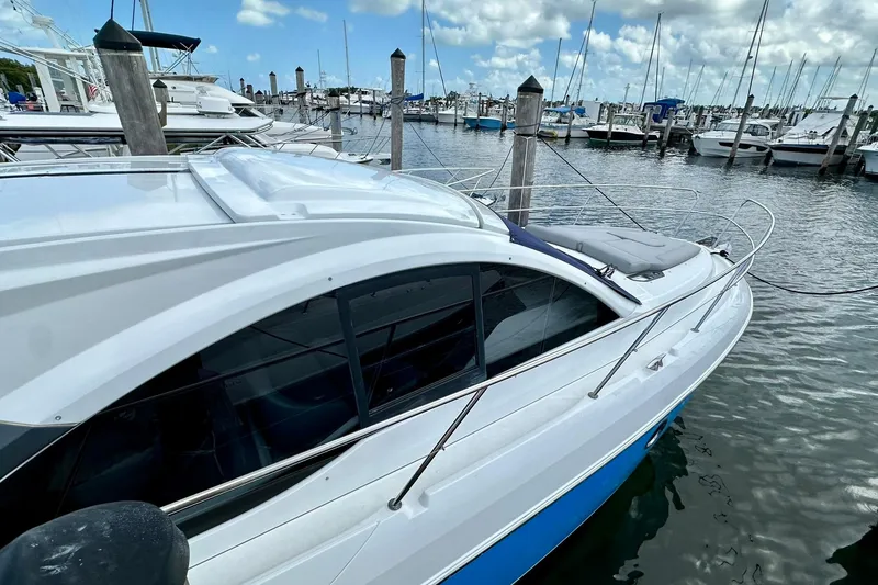 Slide: The Image of 2012 Beneteau Gran Turismo 34 yacht docked at marina, under a partly cloudy sky. - 12