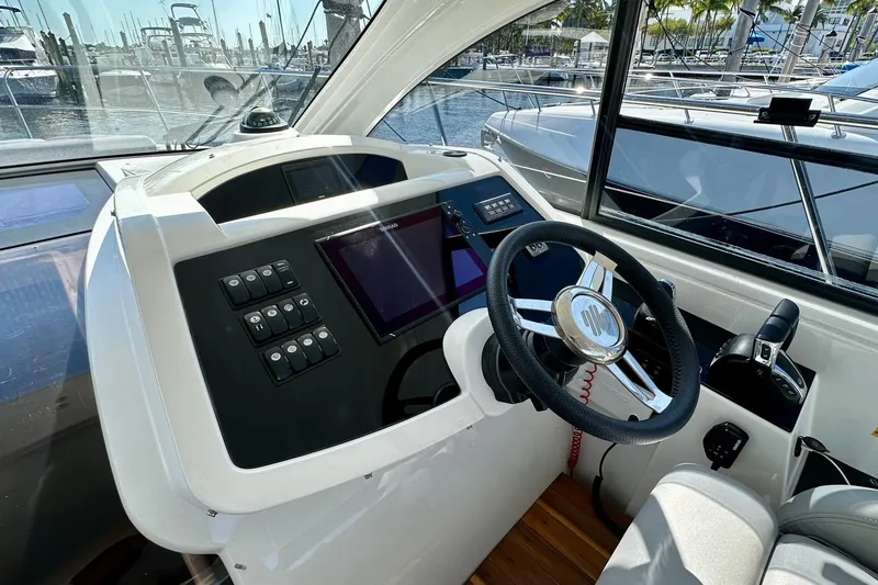 Slide: The Image of Helm of 2012 Beneteau Gran Turismo 34 with modern controls and steering wheel. - 17