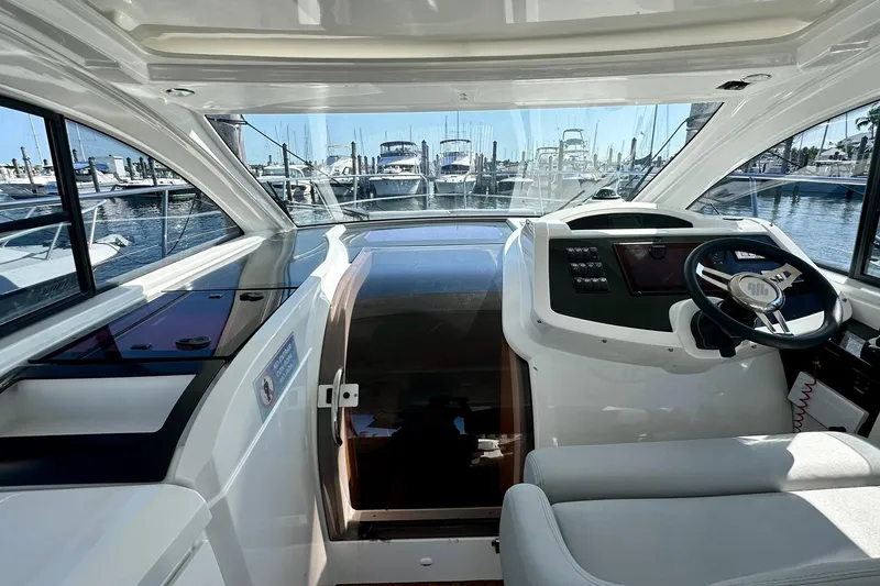 Slide: The Image of Interior view of 2012 Beneteau Gran Turismo 34 yacht cockpit with marina background. - 21