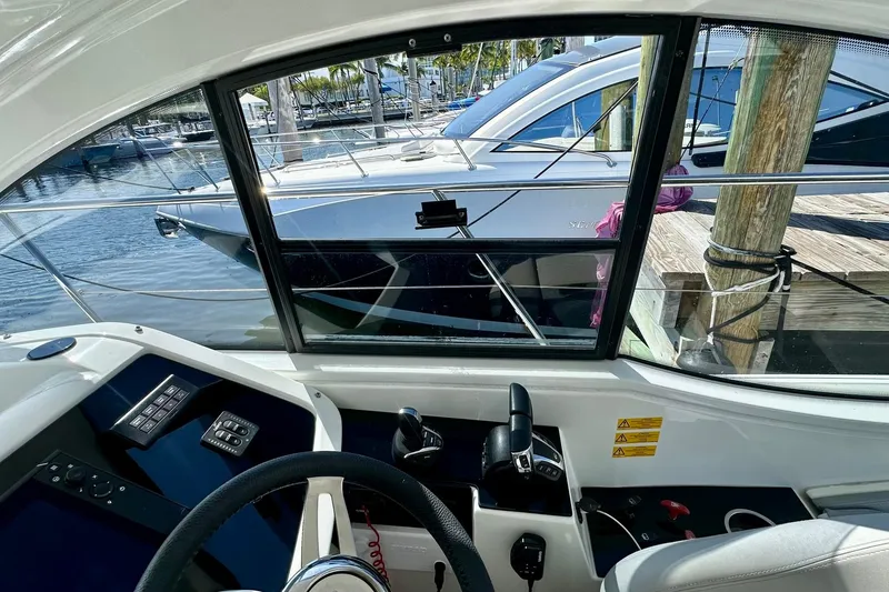 Slide: The Image of Interior view of 2012 Beneteau Gran Turismo 34 yacht cockpit with marina background. - 22