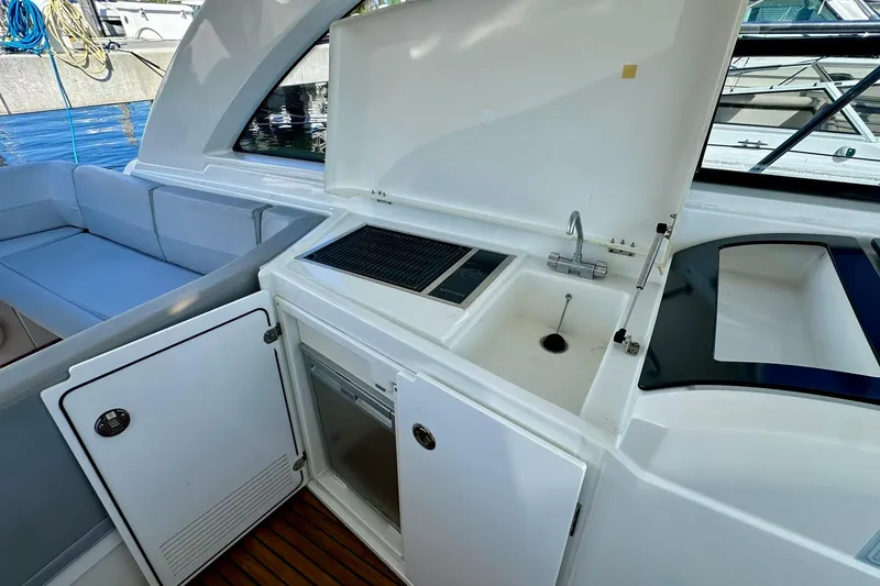 Slide: The Image of 2012 Beneteau Gran Turismo 34 yacht interior with kitchenette and seating area. - 23