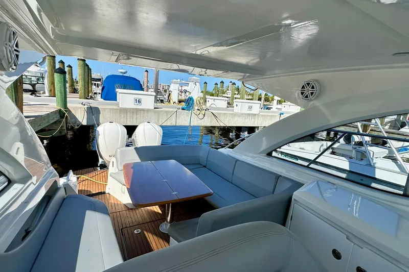 Slide: The Image of 2012 Beneteau Gran Turismo 34 yacht interior with seating and table at marina. - 25
