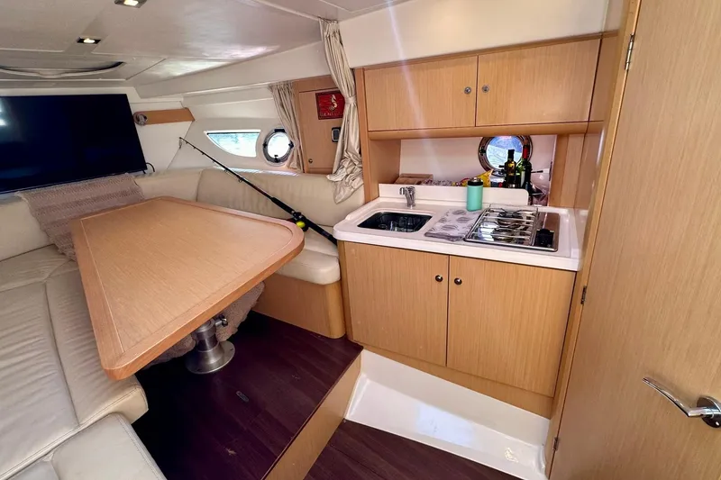 Slide: The Image of Luxurious interior of 2012 Beneteau Gran Turismo 34 yacht with kitchenette and seating area. - 29
