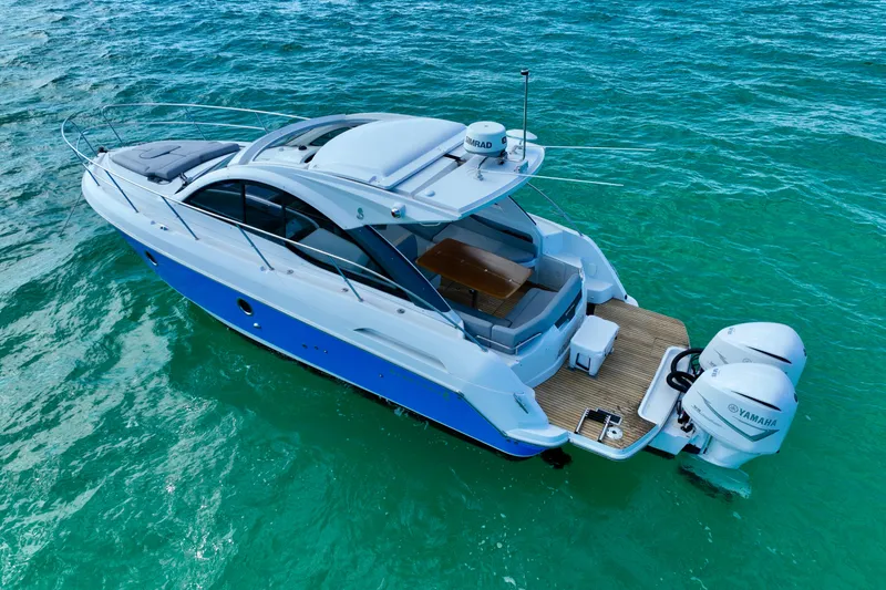 Slide: The Image of 2012 Beneteau Gran Turismo 34 yacht on turquoise water, rear view. - 3