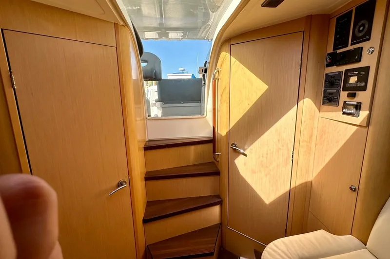 Slide: The Image of Interior of 2012 Beneteau Gran Turismo 34 yacht with wooden cabinetry and stairs. - 30