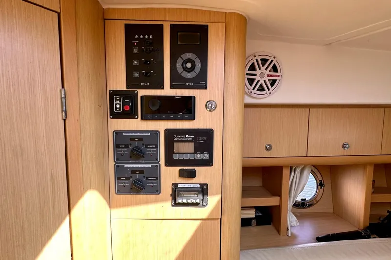 Slide: The Image of Interior of 2012 Beneteau Gran Turismo 34 yacht showing control panel and wooden cabinetry. - 31