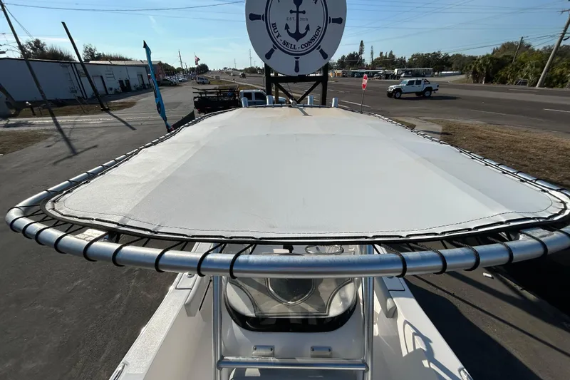 Slide: The Image of 2022 Sea Fox 206 Commander boat with T-top, parked near a road. - 27