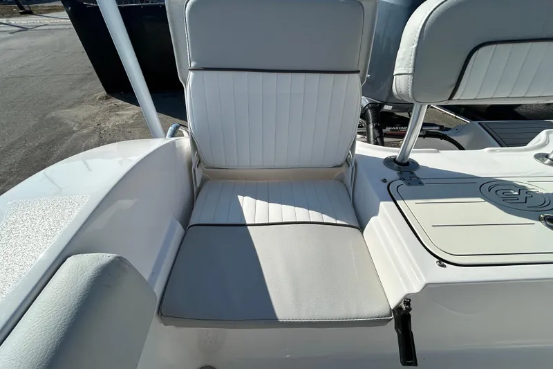 Slide: The Image of 2022 Sea Fox 206 Commander boat seat with white upholstery and storage compartment. - 32