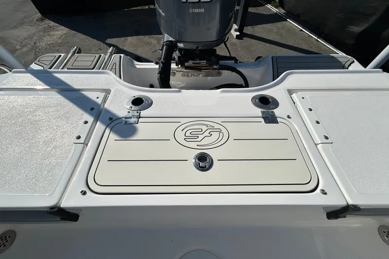 Slide: The Image of 2022 Sea Fox 206 Commander boat deck with Yamaha engine, featuring storage compartments. - 37