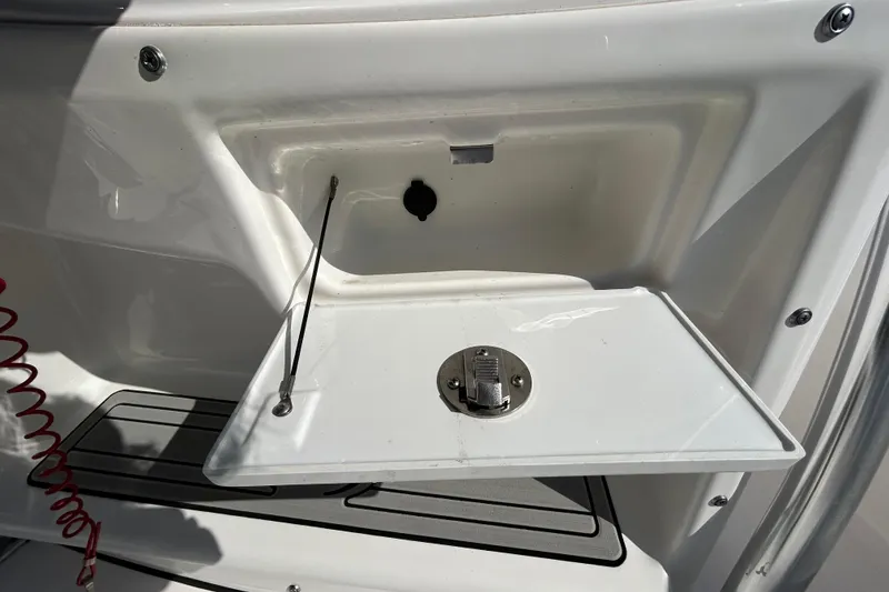 Slide: The Image of 2022 Sea Fox 206 Commander boat storage compartment with latch and cable. - 51
