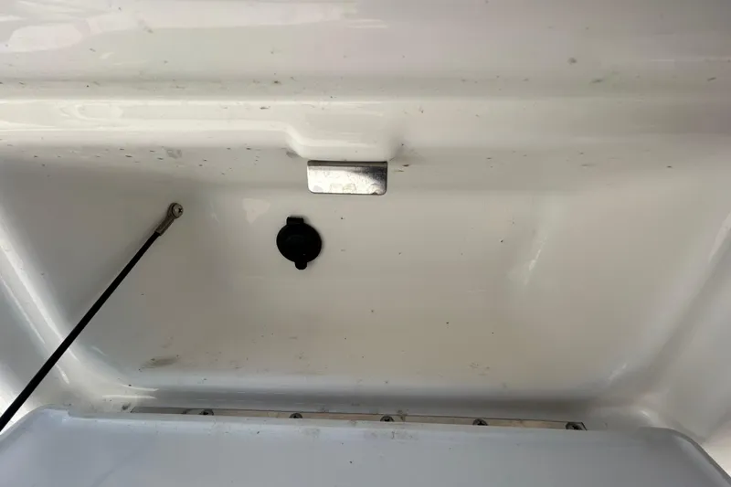 Slide: The Image of Storage compartment of a 2022 Sea Fox 206 Commander boat, featuring a latch and cable. - 52