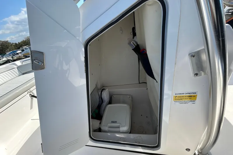 Slide: The Image of 2022 Sea Fox 206 Commander boat storage compartment with open door, showcasing interior space. - 54