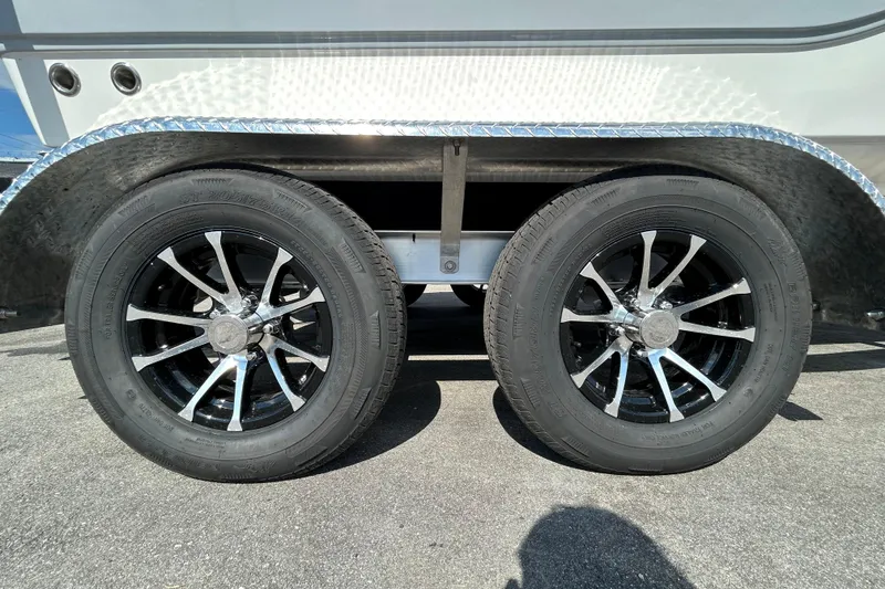Slide: The Image of Dual wheels of a 2022 Sea Fox 206 Commander boat trailer on pavement. - 69