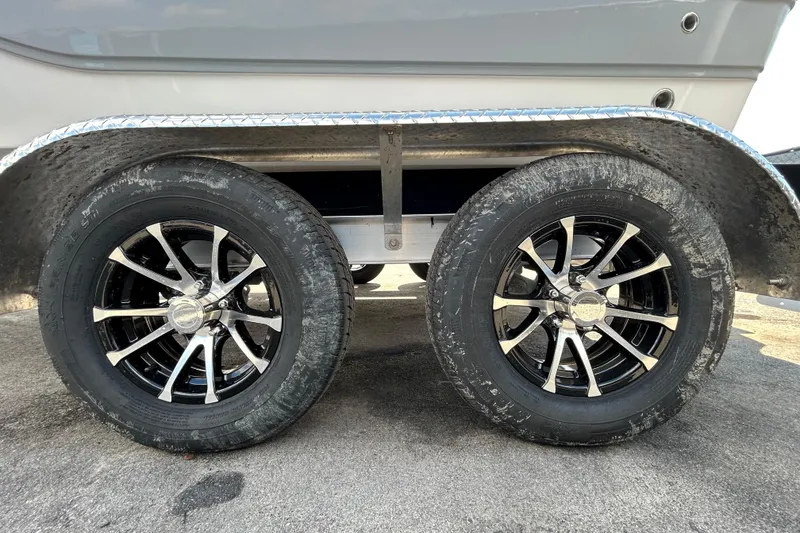 Slide: The Image of Trailer wheels of a 2022 Sea Fox 206 Commander boat on pavement. - 70